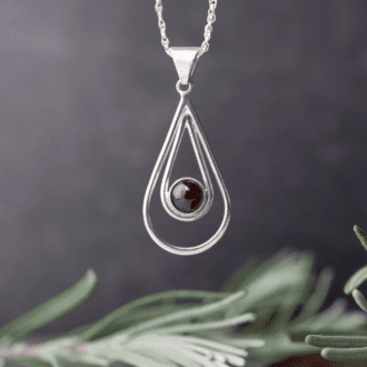 silver wire open teardrop shape with garnet stone in centre.