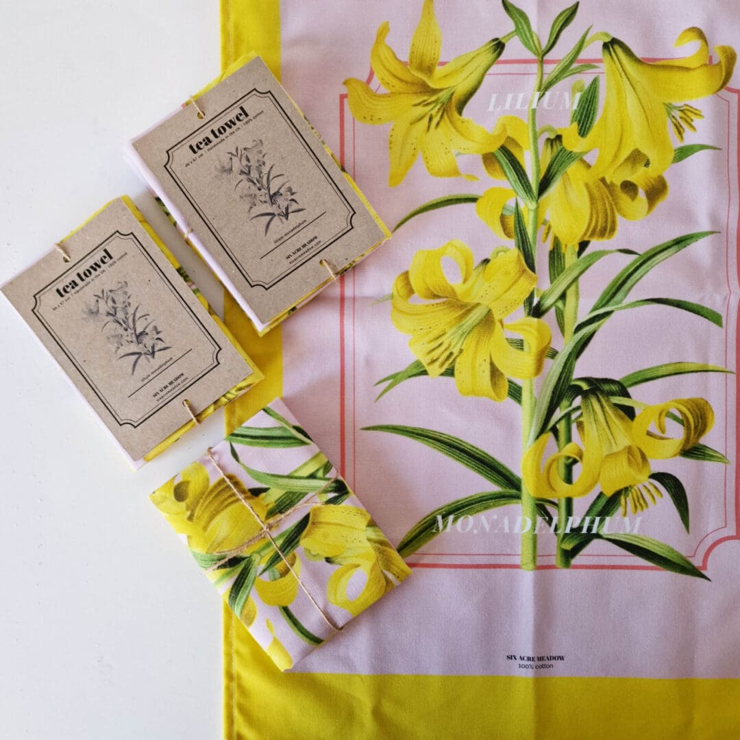 photo of a handmade lily print cotton tea towel in yellow and pink