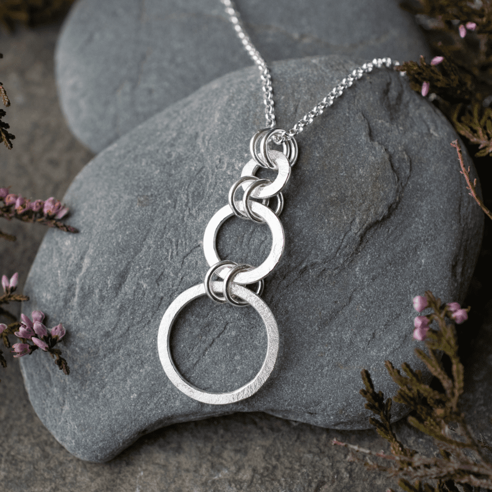 silver necklace with three open circles of increasing size