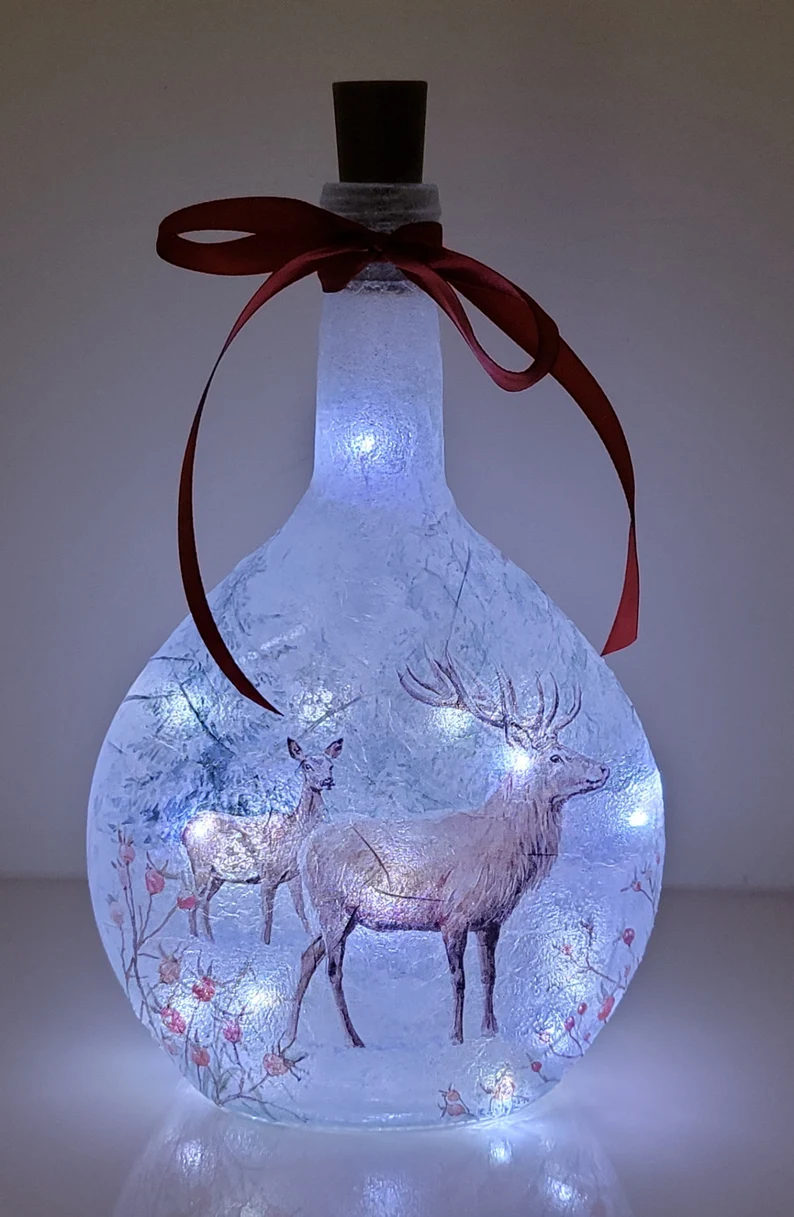 Lit up Round bottle with Stag detailing and decorative red ribbon