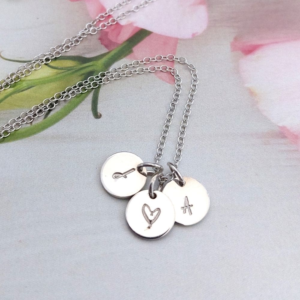 sterling silver 3 tiny disc necklace with 2 hand-stamped initial discs and a heart disc in between