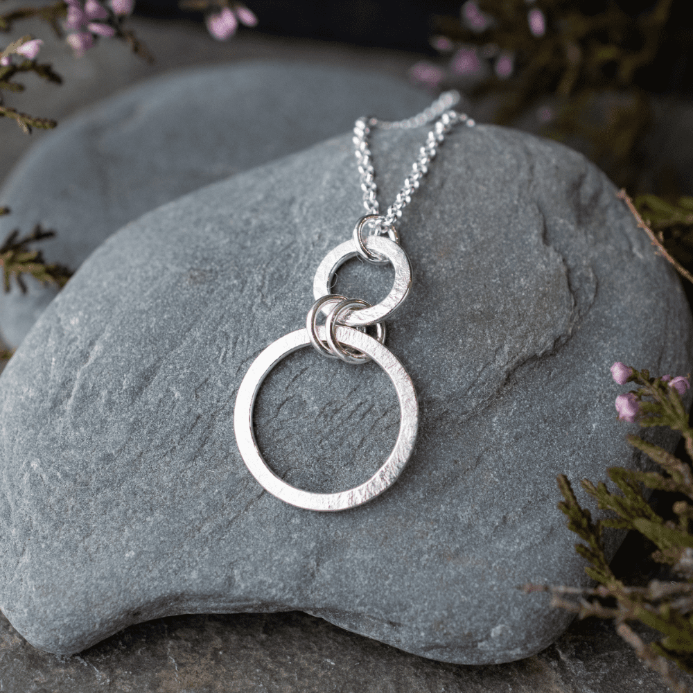 silver necklace with two open circles of increasing size