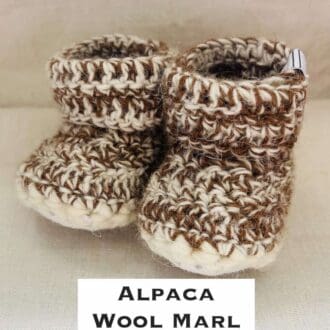 Pair of brown and ecru marl baby booties crocheted with a sheepskin sole in Scottish Alpaca and Handspun wool by Midge Porter Design