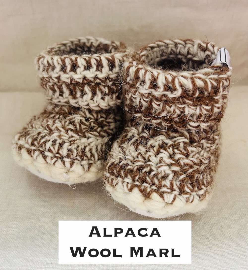 Pair of brown and ecru marl baby booties crocheted with a sheepskin sole in Scottish Alpaca and Handspun wool by Midge Porter Design