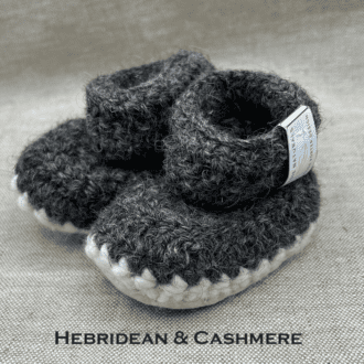 Pair of mid grey baby booties crocheted with a sheepskin sole in Hebridean and cashmere wool by Midge Porter Design