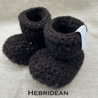 Pair of dark brown baby booties crocheted with a sheepskin sole in Hebridean wool by Midge Porter Design