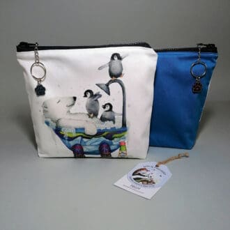 Charming toiletries bag crafted from high-quality cotton and features an irresistible print of a polar bear sharing a bathtub with three penguins. Turquoise on reverse. Secured with a chunky zipper adorned with a stylish chain and ring zip pull, and finished with a sparkling bear paw charm.With water resistant lining and an internal pocket