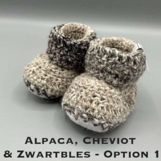 Pair of brown marl baby booties crocheted with a sheepskin sole in Cheviot, Zwartbles and Alpaca wool by Midge Porter Design