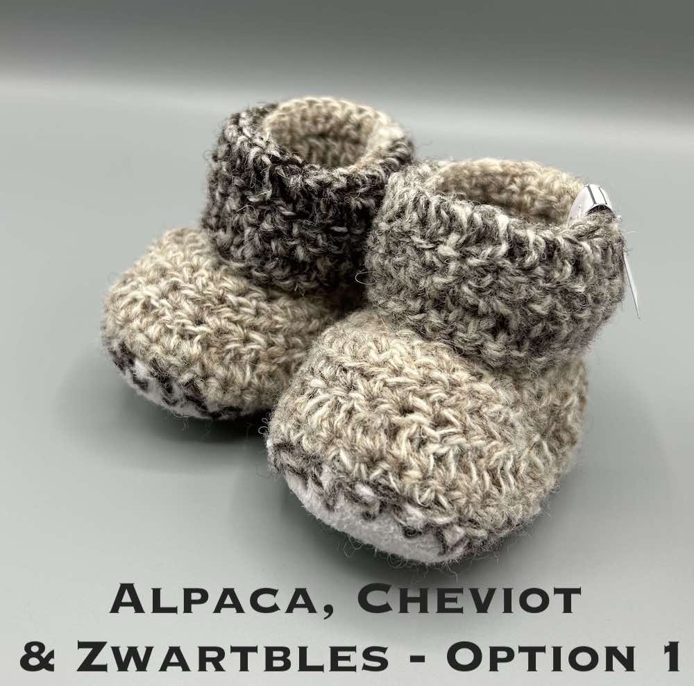 Pair of brown marl baby booties crocheted with a sheepskin sole in Cheviot, Zwartbles and Alpaca wool by Midge Porter Design