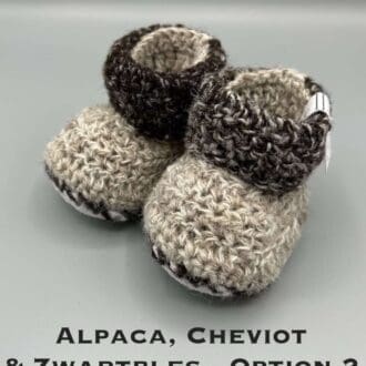 Pair of brown marl baby booties crocheted with a sheepskin sole in Cheviot, Zwartbles and Alpaca wool by Midge Porter Design