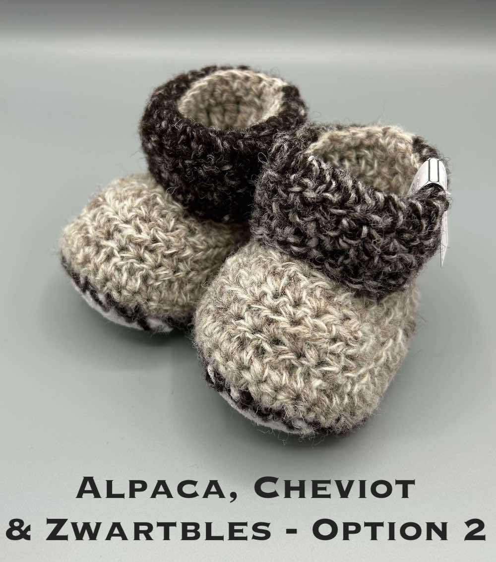 Pair of brown marl baby booties crocheted with a sheepskin sole in Cheviot, Zwartbles and Alpaca wool by Midge Porter Design