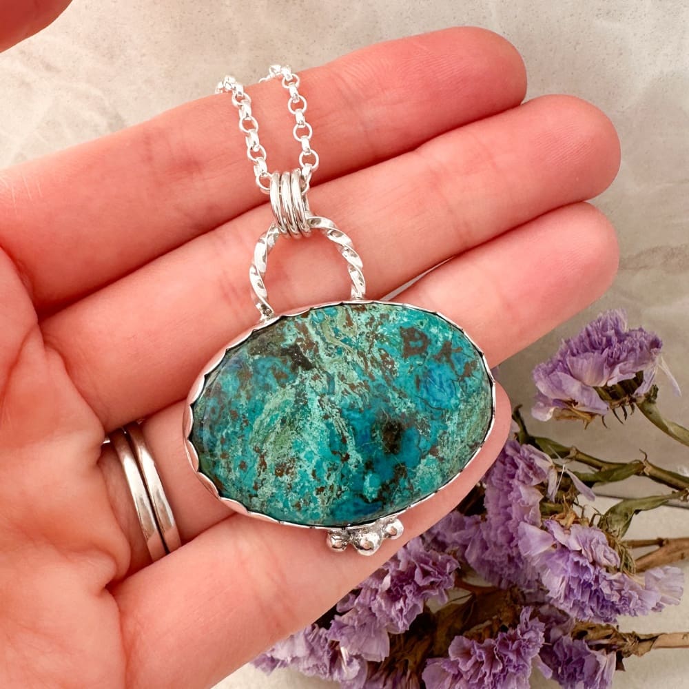 Blue and green shattuckite gemstone set in a handmade silver necklace