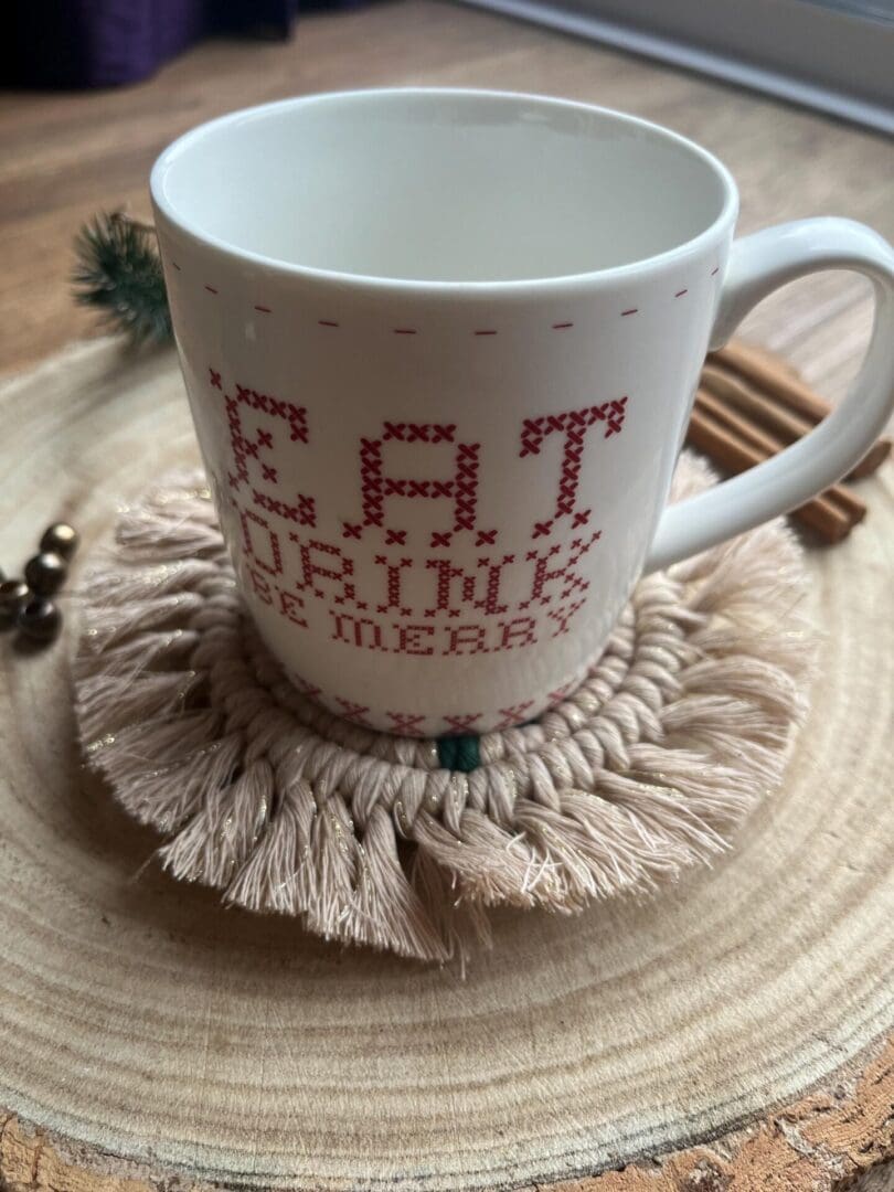 Handmade macrame coaster made with recycled cotton, with a Christmas tree design