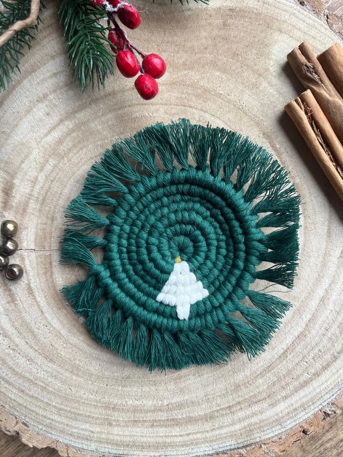 Handmade macrame coaster made with recycled cotton, with a Christmas tree design