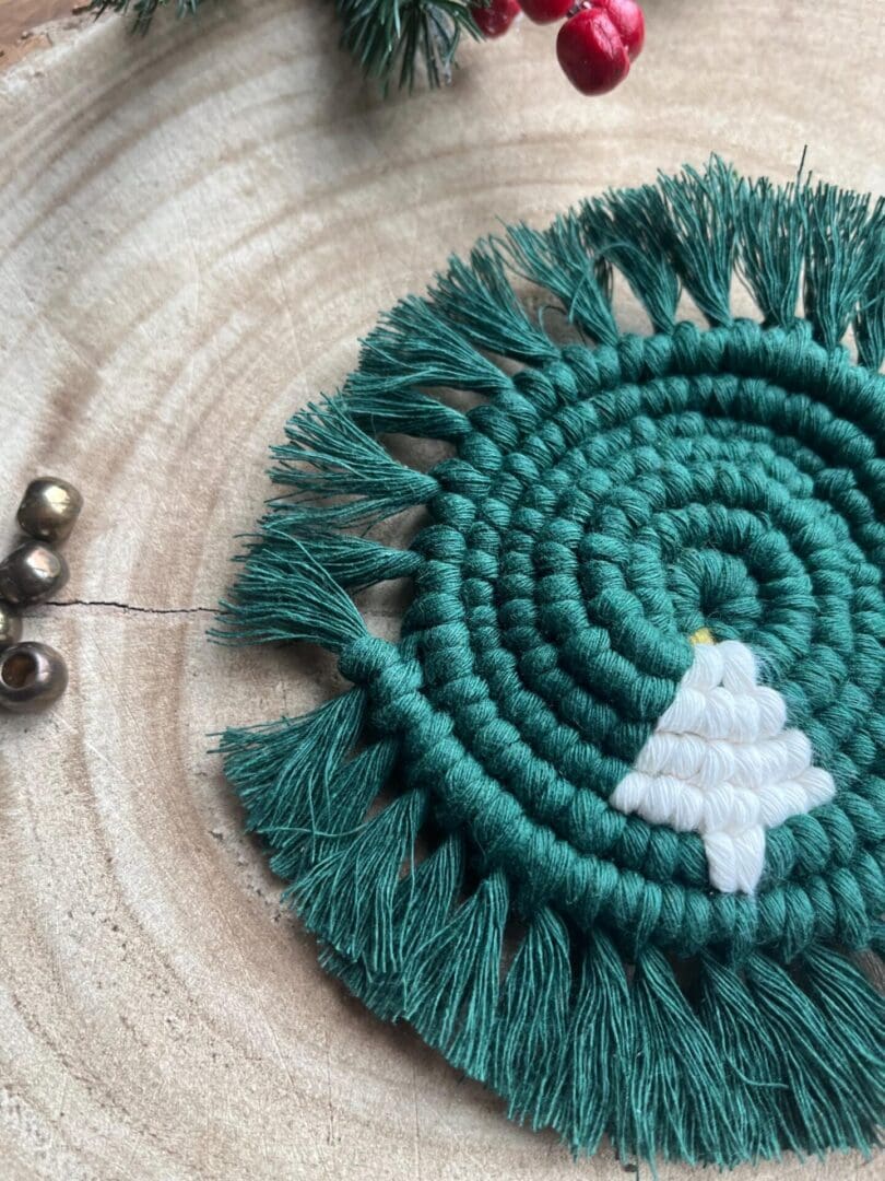 Handmade macrame coaster made with recycled cotton, with a Christmas tree design