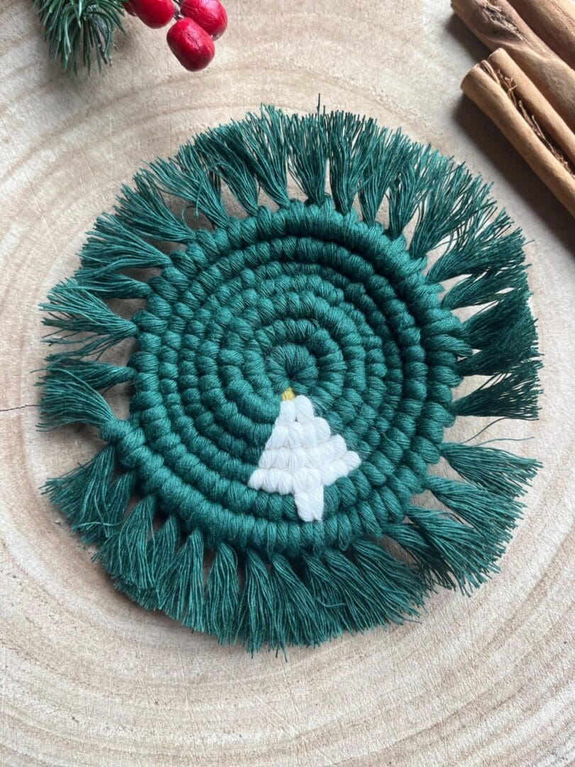 Handmade macrame coaster made with recycled cotton, with a Christmas tree design