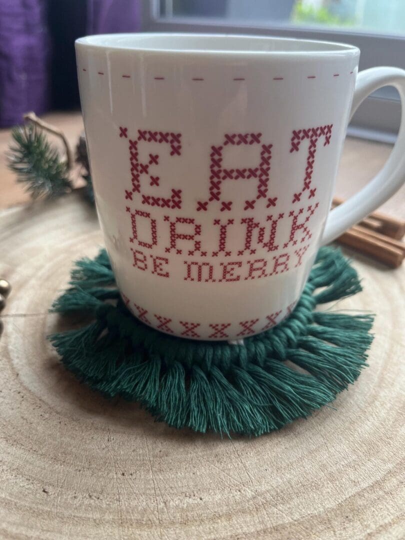 Handmade macrame coaster made with recycled cotton, with a Christmas tree design