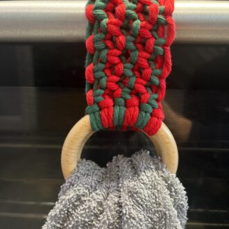 Handmade macrame tea towel holder, in festive Christmas colours of red and green, made with recycled cotton