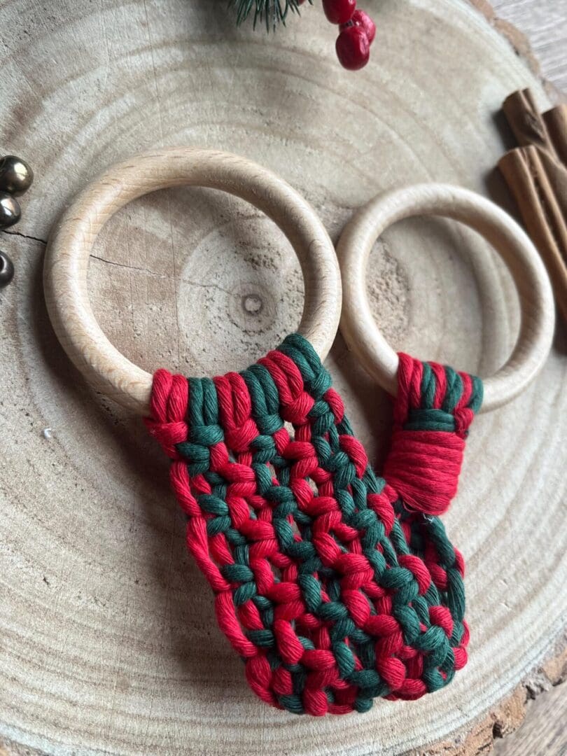 Handmade macrame tea towel holder, in festive Christmas colours of red and green, made with recycled cotton