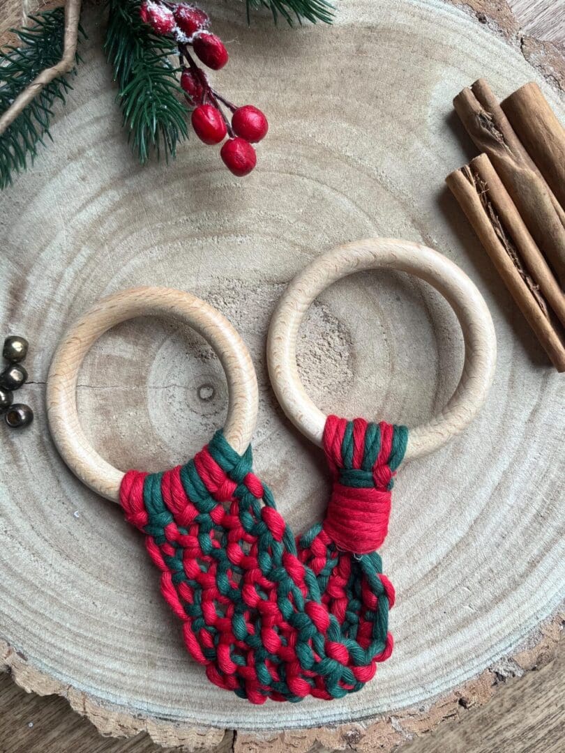 Handmade macrame tea towel holder, in festive Christmas colours of red and green, made with recycled cotton