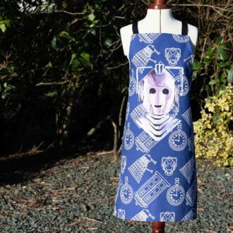 Cyberman inspired adult cotton apron on blue in the garden