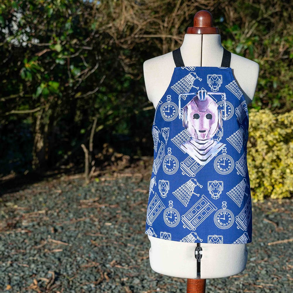 Cyberman inspired kids cotton apron on blue in the garden