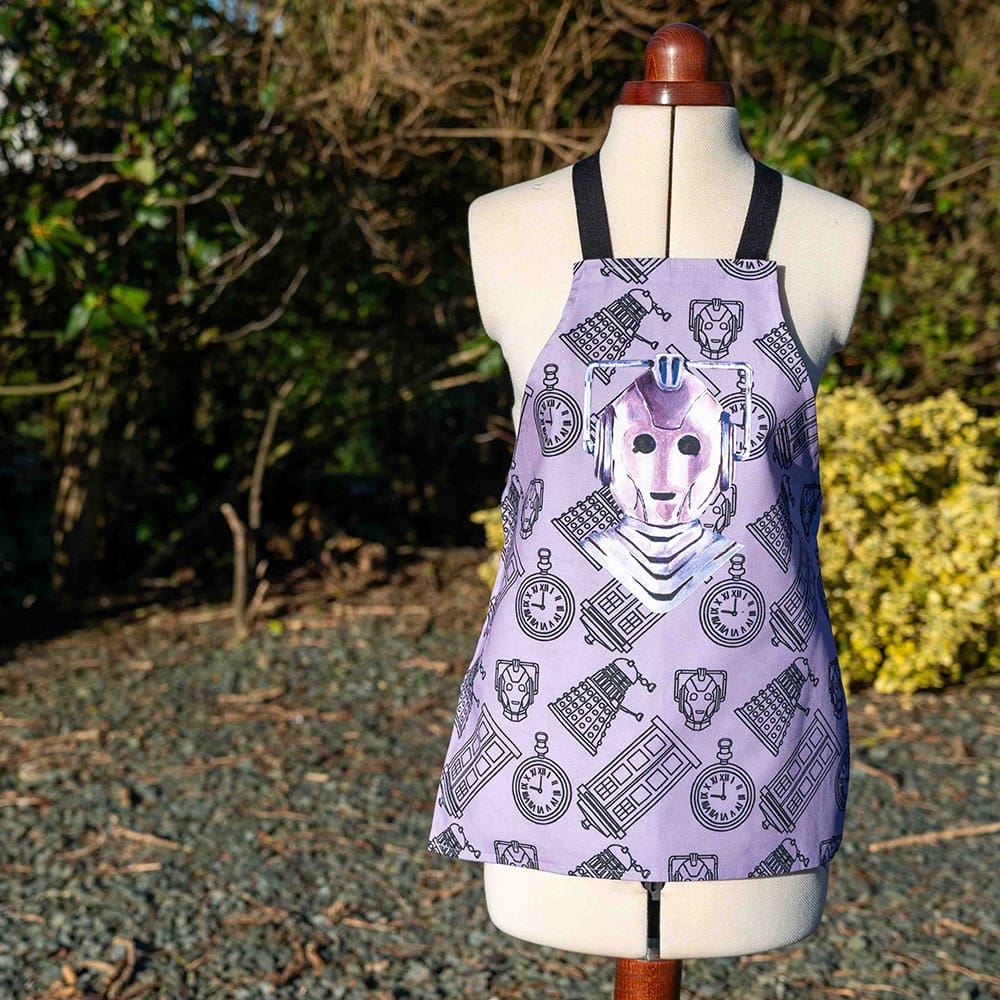 Cyberman inspired kids cotton apron on lilac in the garden