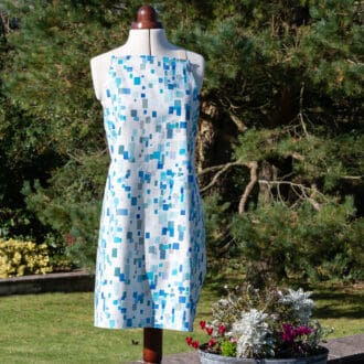 Designer cotton apron spring blue white on display