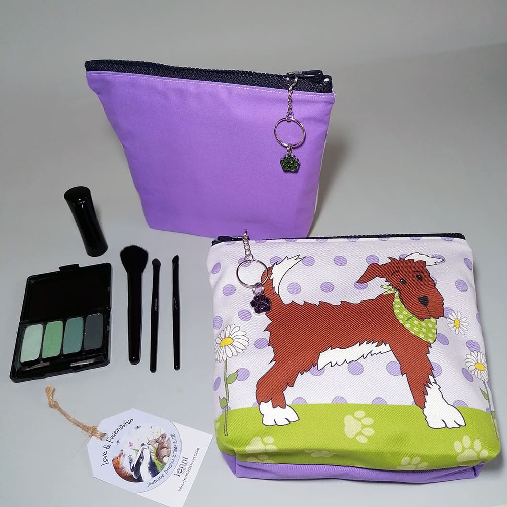 Purple and green make up purse featuring a dog-in-a-bandana print.