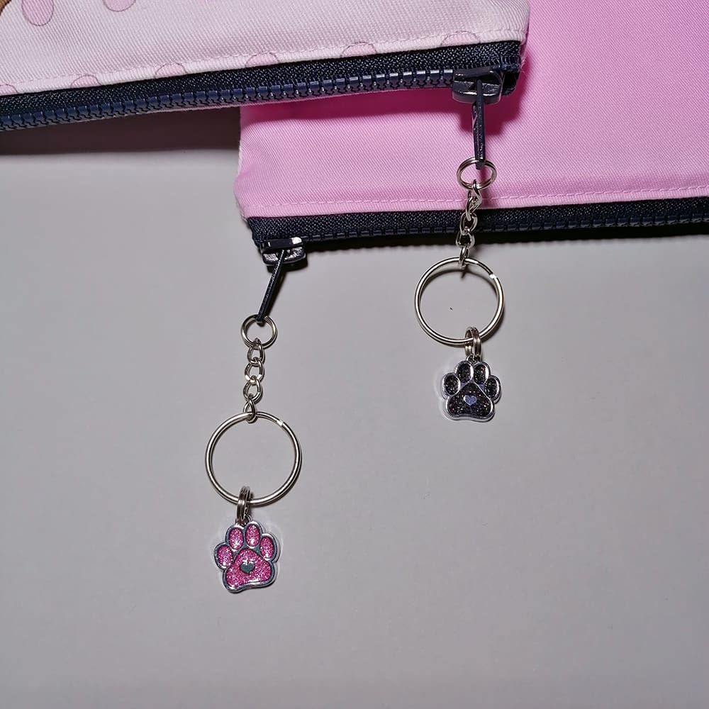 Two cute pups pink make up bag sealed with a chunky zipper featuring a chain and Ring zip pull with a sparkly dog paw charm