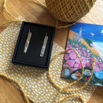 Your jewellery in an Arvor and Mor branded box next to eco-friendly gift wrap, twine, and card. Opt to send your jewellery gift-wrapped directly to the recipient.