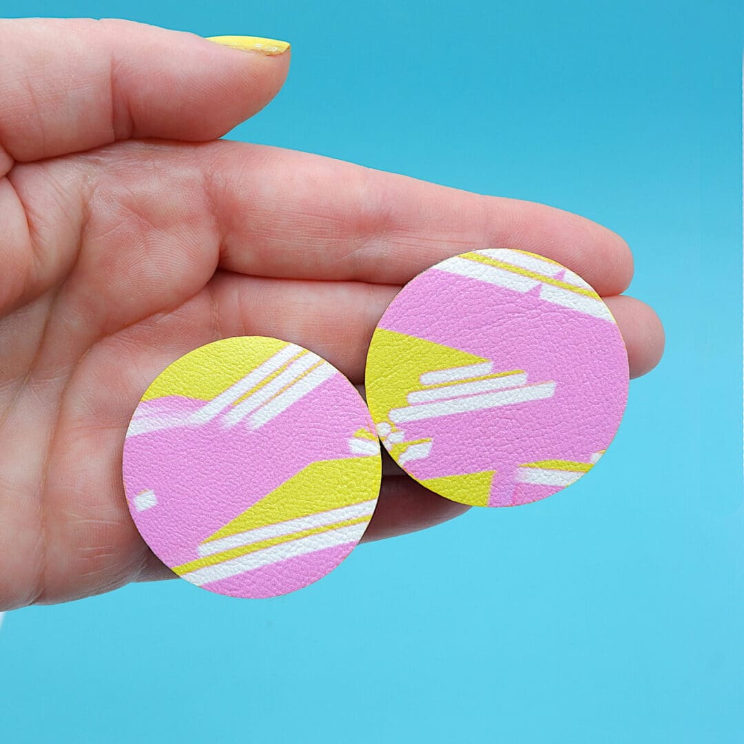 Graffiti inspired abstract art round stud earrings. Yellow and pink painted design