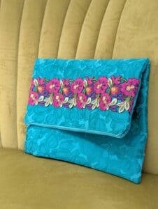 Handmade green foldover clutch bag with beautiful floral trim embroidered on the front