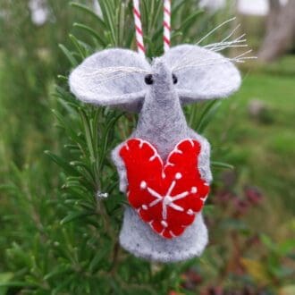 Handstitched grey felt christmas mouse holding a red felt heart with a white scandi embroidery