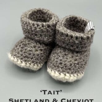 Pair of mid grey baby booties crocheted with a sheepskin sole in Shetland and Cheviot wool by Midge Porter Design