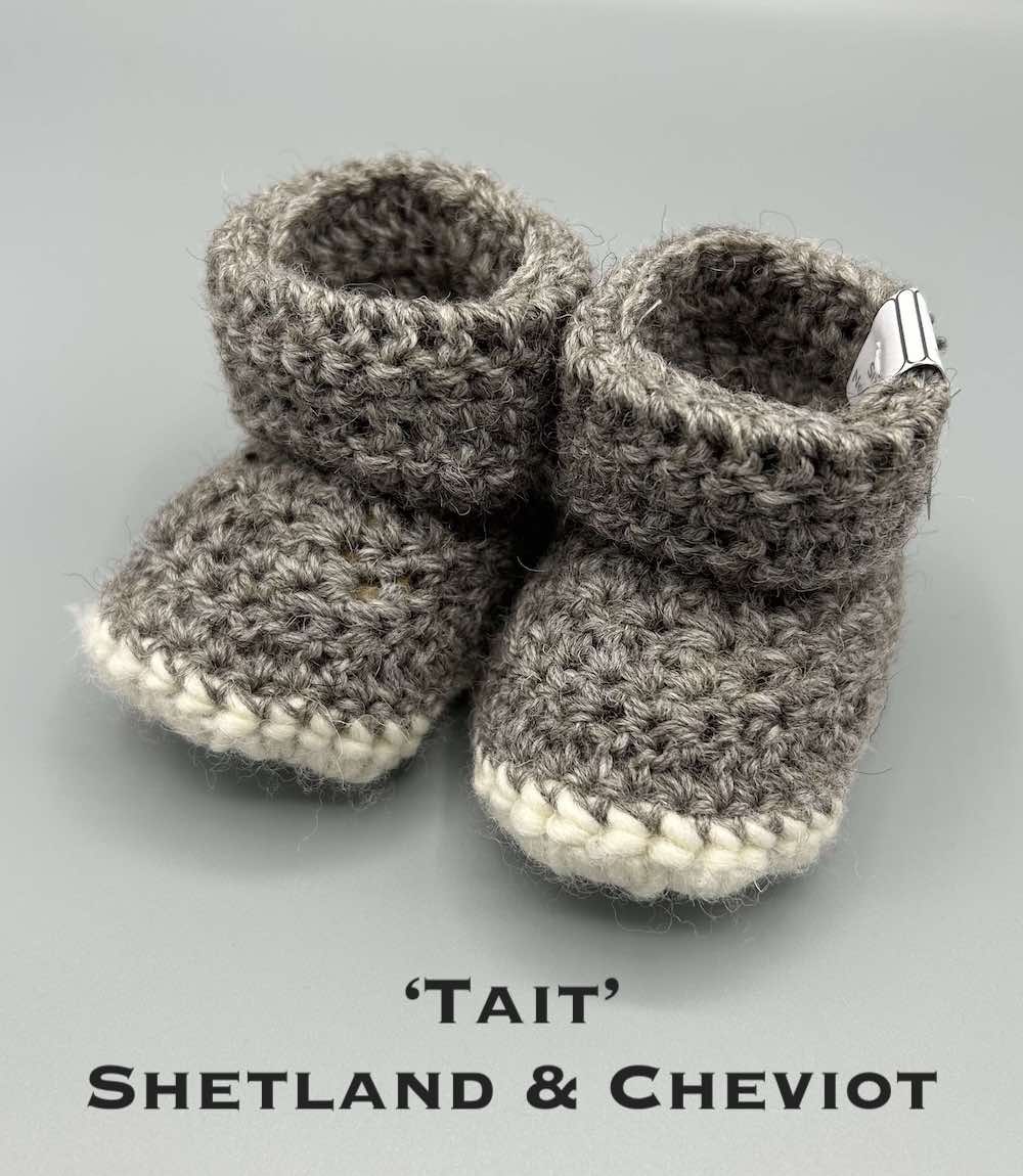 Pair of mid grey baby booties crocheted with a sheepskin sole in Shetland and Cheviot wool by Midge Porter Design