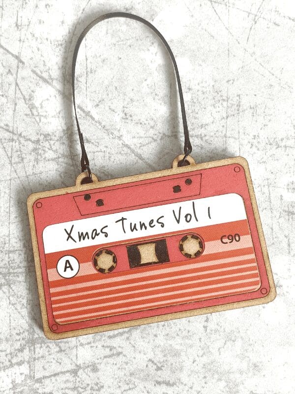 Cassette tape decoration with a red label that says Xmas Tunes Vol 1