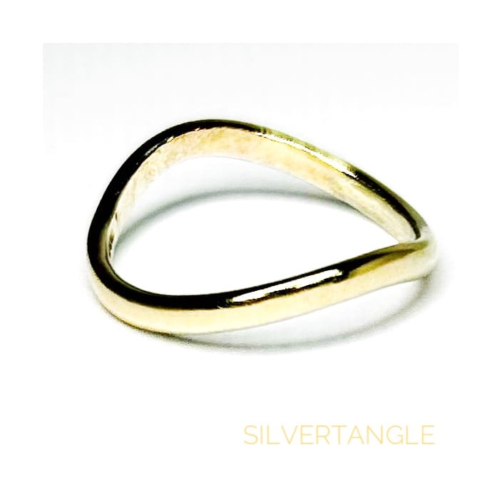 Wavy Gold Thumb Ring on a white background