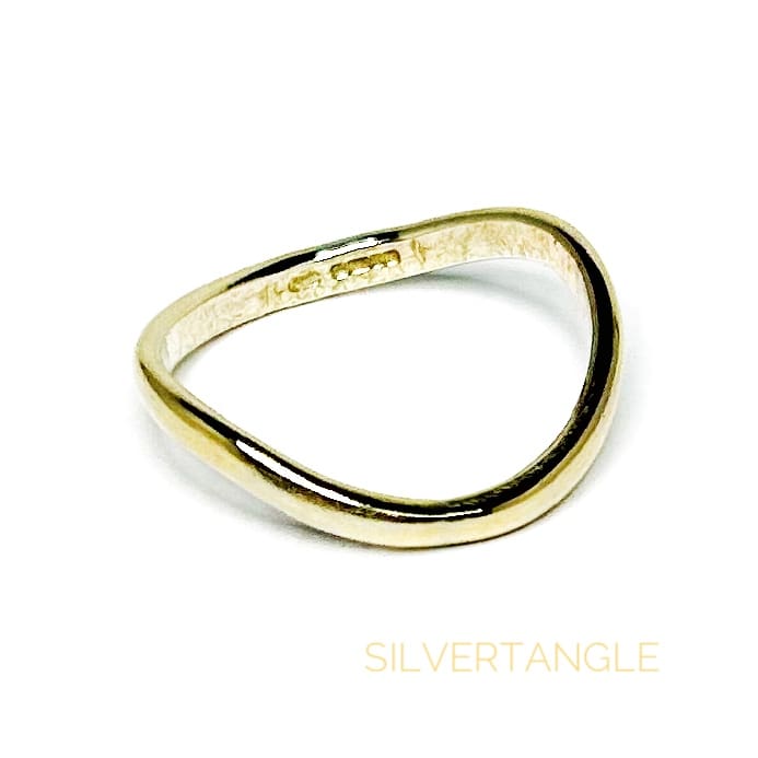 Wavy Gold Thumb Ring on a white background