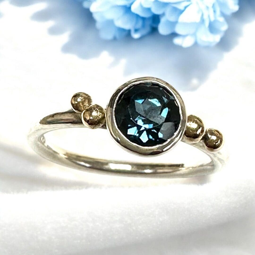 Beautiful London Blue Topaz Ring with Gold Accent to the ring shoulders