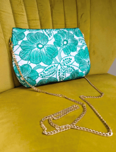 Floral shoulder bag in white and green with a gold coloured chain