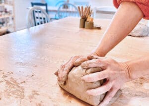 Wedging clay in the studio