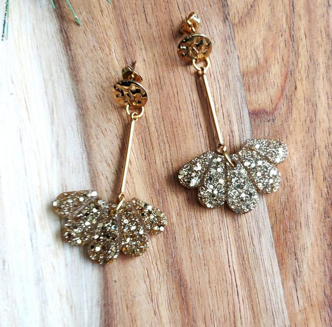 art deco inspired fan drop earrings made in gold glitter.