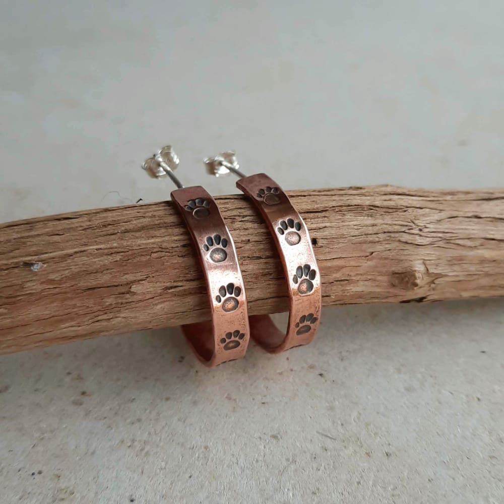 Boho style copper paw print hoop earrings, hand forged by The Tiny Tree Frog Jewellery