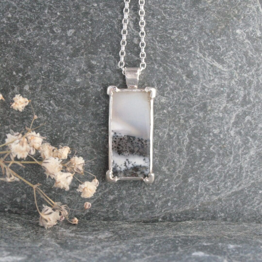 Rectangular dendritic opal gemstone necklace with a tree cut-out on the back