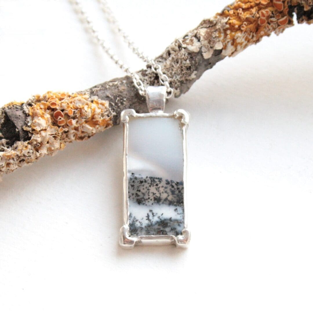 Rectangular dendritic opal gemstone necklace with a tree cut-out on the back