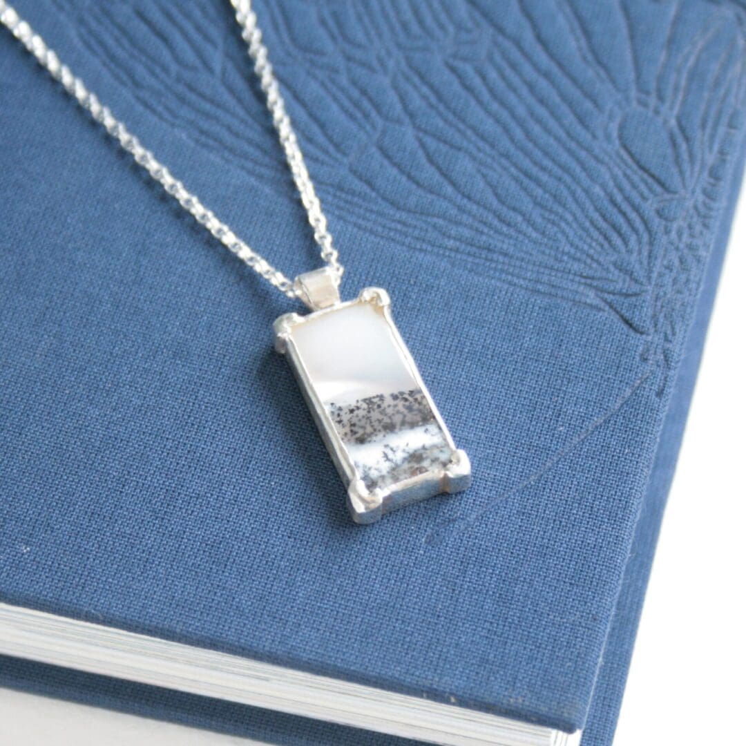 Rectangular dendritic opal gemstone necklace with a tree cut-out on the back