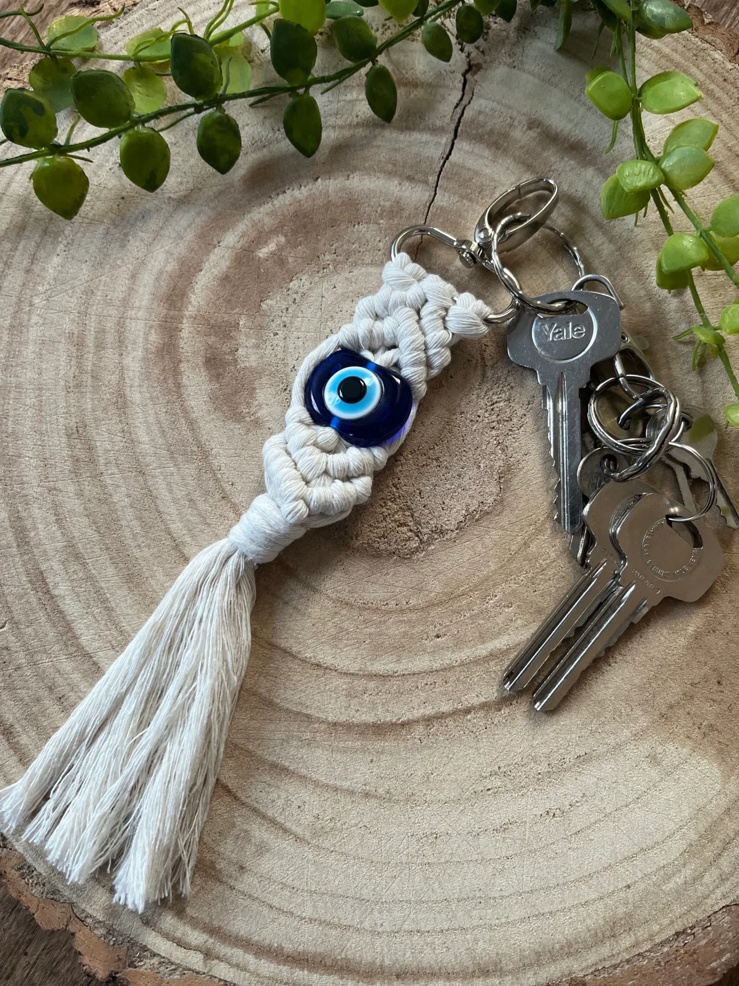 Evil eye bead macrame keychain made with recycled cotton and a resin bead, on a metal lobster clasp