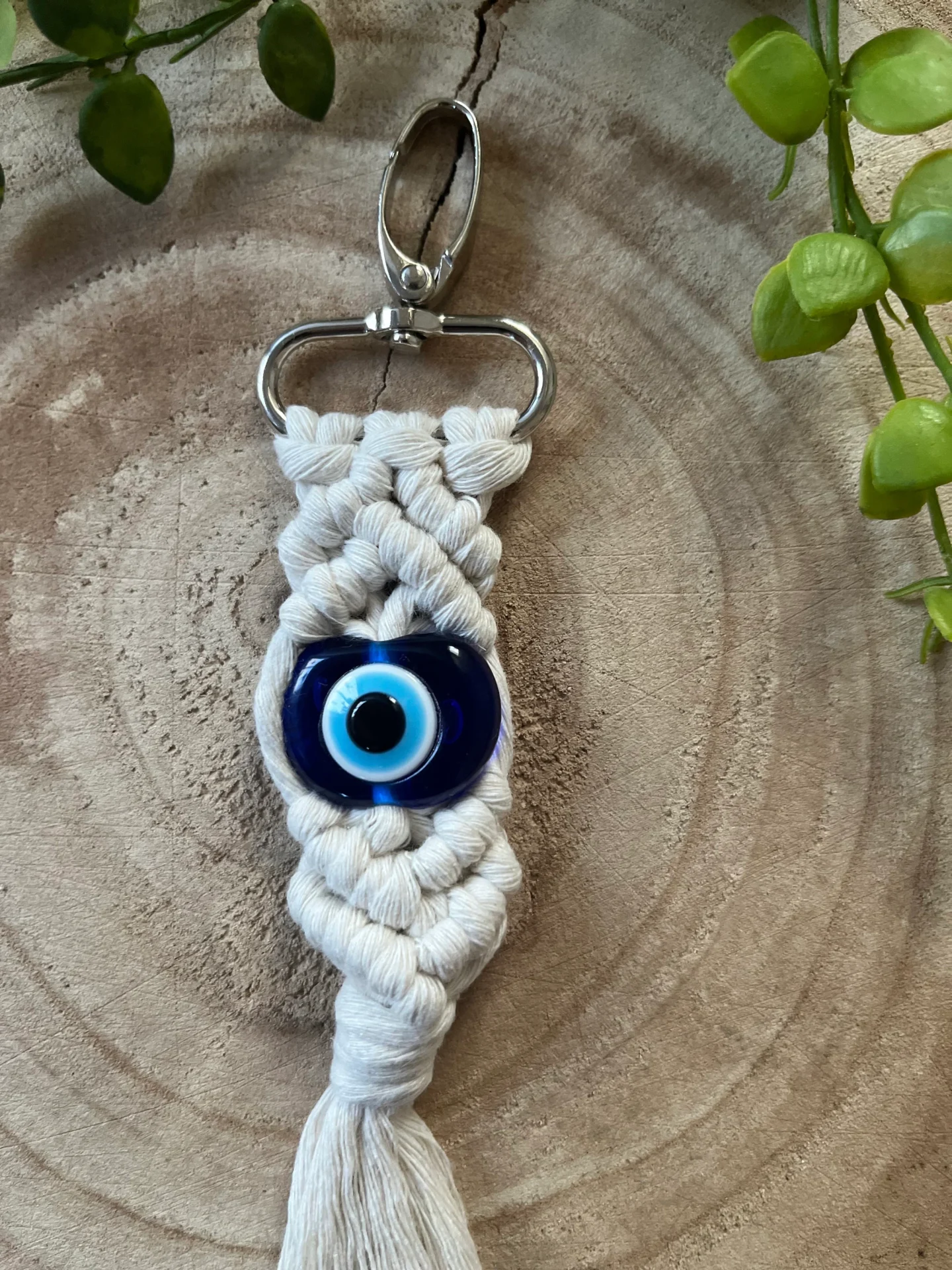 Evil eye bead macrame keychain made with recycled cotton and a resin bead, on a metal lobster clasp