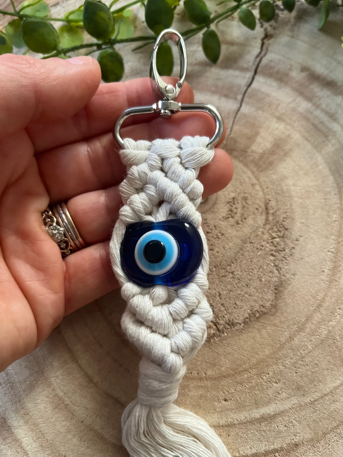 Evil eye bead macrame keychain made with recycled cotton and a resin bead, on a metal lobster clasp